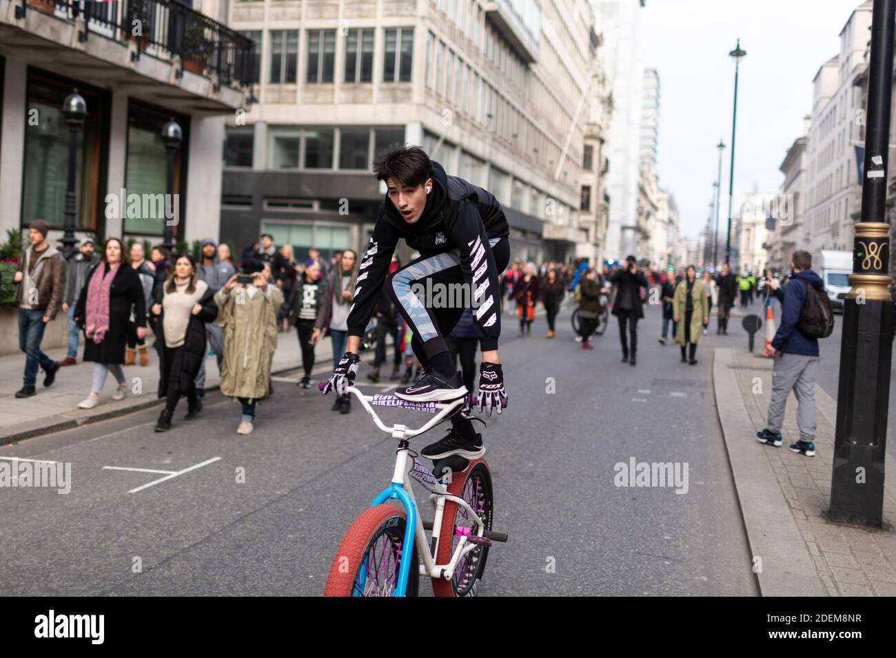 Manifestation anti-verrouillage, Regent Street, Londres, 28 novembre 2020. Un jeune homme se tient au sommet de son vélo sur la route. Banque D'Images