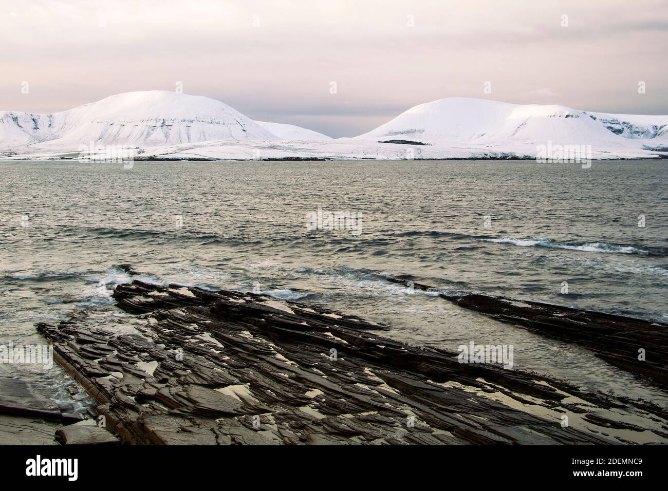 Collines blanches couvertes de neige et d'eaux sombres de l'Atlantique océan sur les îles Orcades Banque D'Images