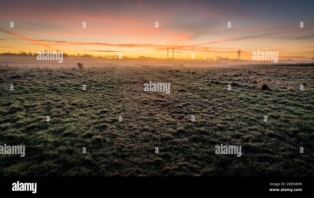 Matin herbe givrée au premier plan dans le lever du soleil matin automnal paysage Banque D'Images