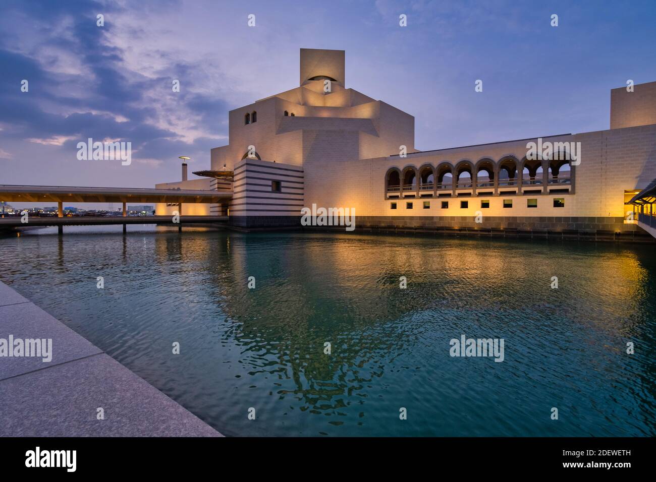 Musée d'art islamique, Doha, Qatar à la tombée de la nuit vue extérieure montrant l'architecture moderne du bâtiment avec réflexion lumineuse dans le golfe arabe Banque D'Images