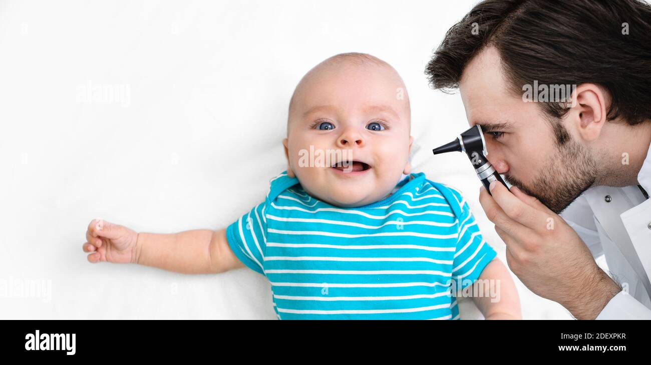 Un pédiatre masculin examine l'oreille d'un bébé de 3 mois avec un otoscope. Enfant recevant un test auditif Banque D'Images