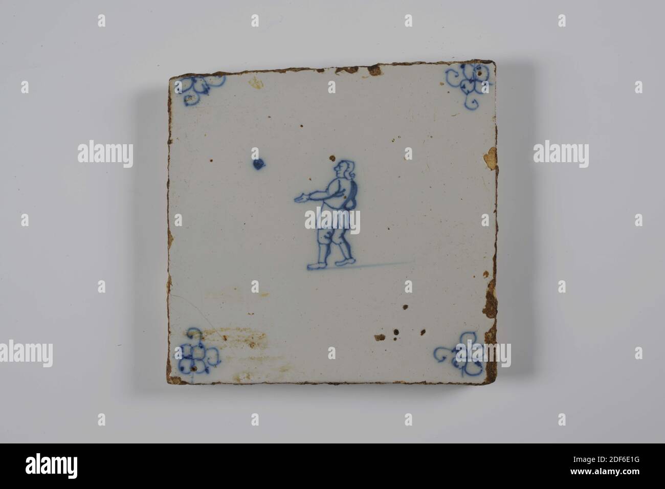 Carreau de mur, Anonyme, entre 1775-1850, glaçure d'étain, faïence, général: 12.8 x 13 x 1 cm (128 x 130 x 10mm), jeu d'enfant, garçon, carreau de mur de faïence recouvert de glaçure d'étain et peint en bleu. Le jeu de l'enfant est représenté sur le carreau. La tuile au centre représente un garçon orienté à gauche avec une balle. Le garçon a la main gauche orientée vers l'avant. La tuile a une araignée comme un motif de coin, 1995 Banque D'Images