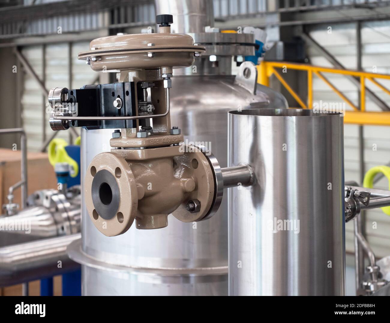 Soupape modulatrice montée sur un tuyau en acier inoxydable dans une usine de traitement. Les soupapes modulatrices sont utilisées pour régler le débit en fonction des paramètres secondaires Banque D'Images