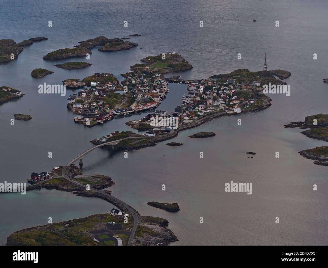 Belle vue aérienne du petit village de pêcheurs Henningsvær, Austvågøya, Lofoten, Norvège avec port, pont et terrain de football populaire entre les rochers. Banque D'Images