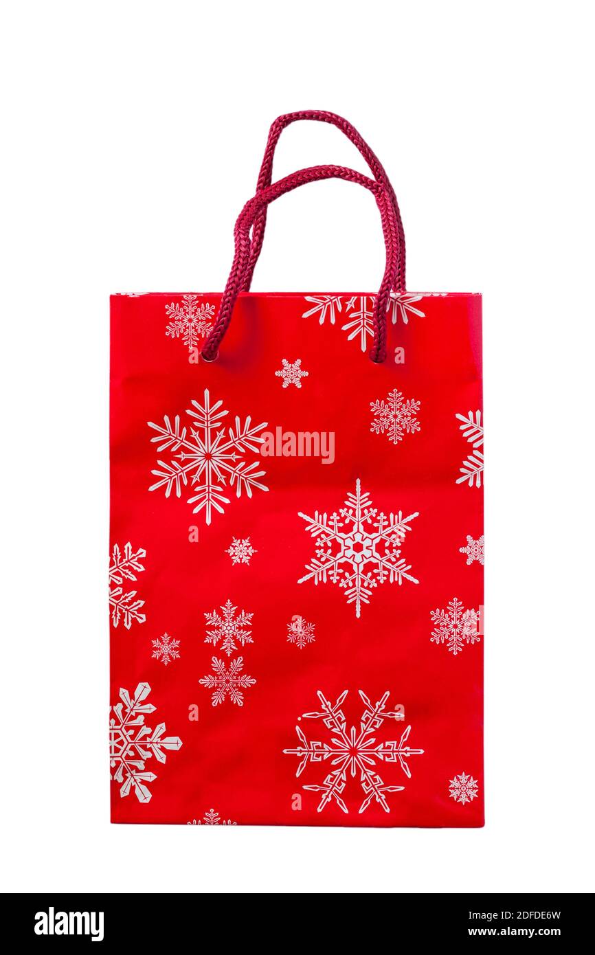 Sac cadeau de Noël rouge avec flocons de neige blancs sur isolé arrière-plan blanc Banque D'Images