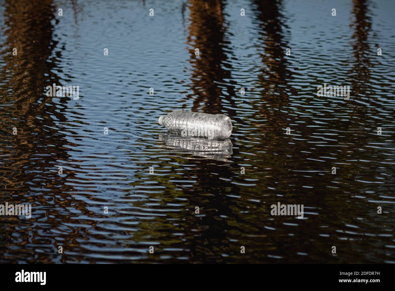 Bouteille en plastique dans la rivière. Concept de l'environnement et de la pollution. Banque D'Images