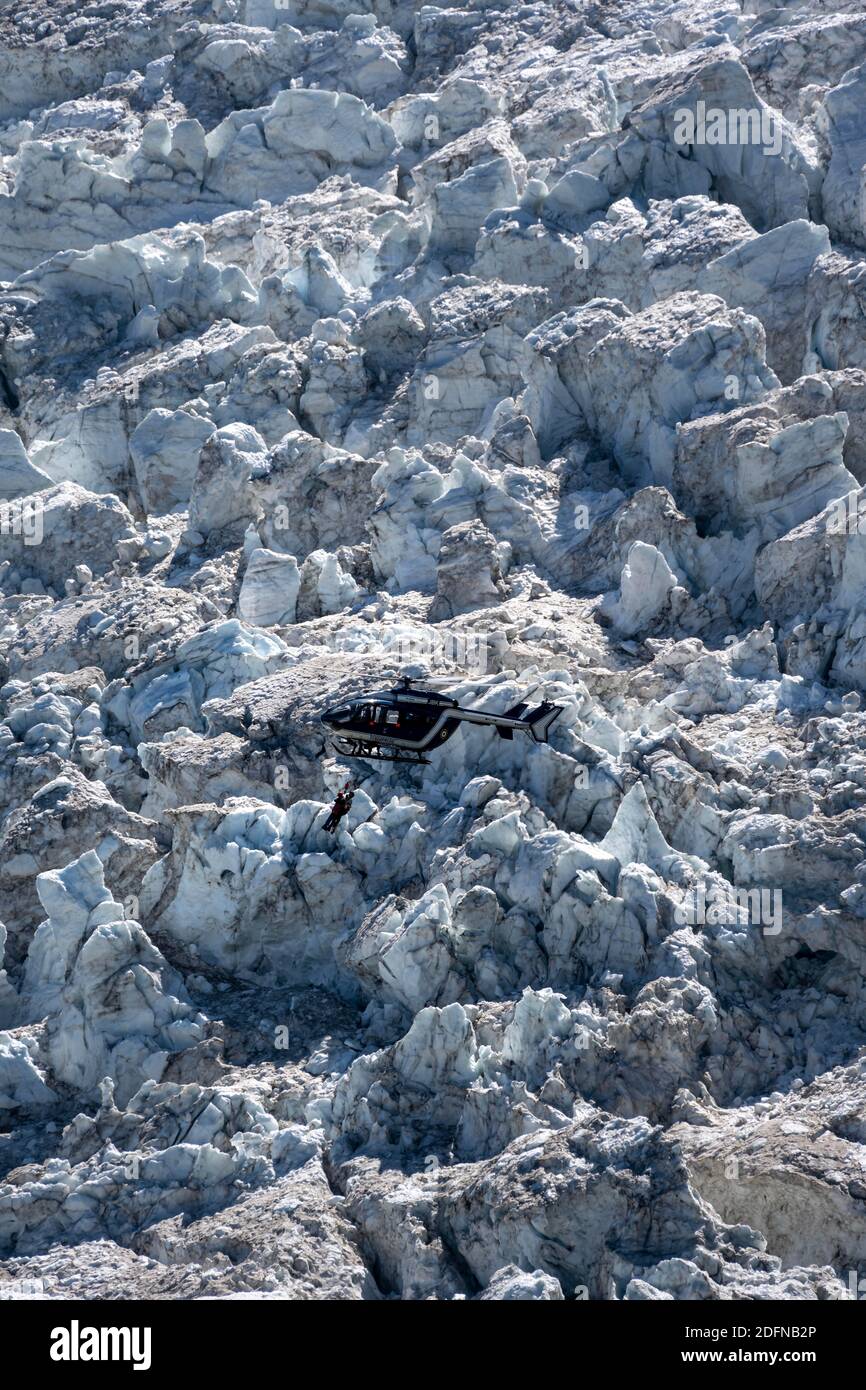 Personne blessée sur corde, hélicoptère volant au-dessus du glacier, Glacier de Bossons, sauvetage alpin, sauvetage en montagne, Chamonix, haute-Savoie, France Banque D'Images