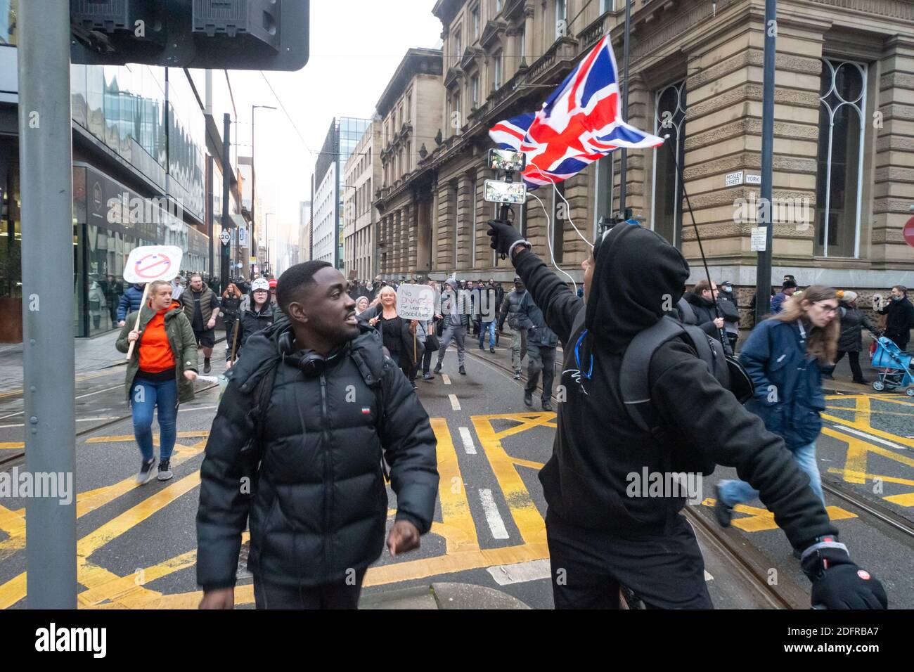 Manchester le 6 décembre 2020: Une marche de protestation pour les libertés, l'anti-verrouillage, système anti-Tier. Un homme sur un vélo en direct de l'événement à l'approche de la foule Banque D'Images