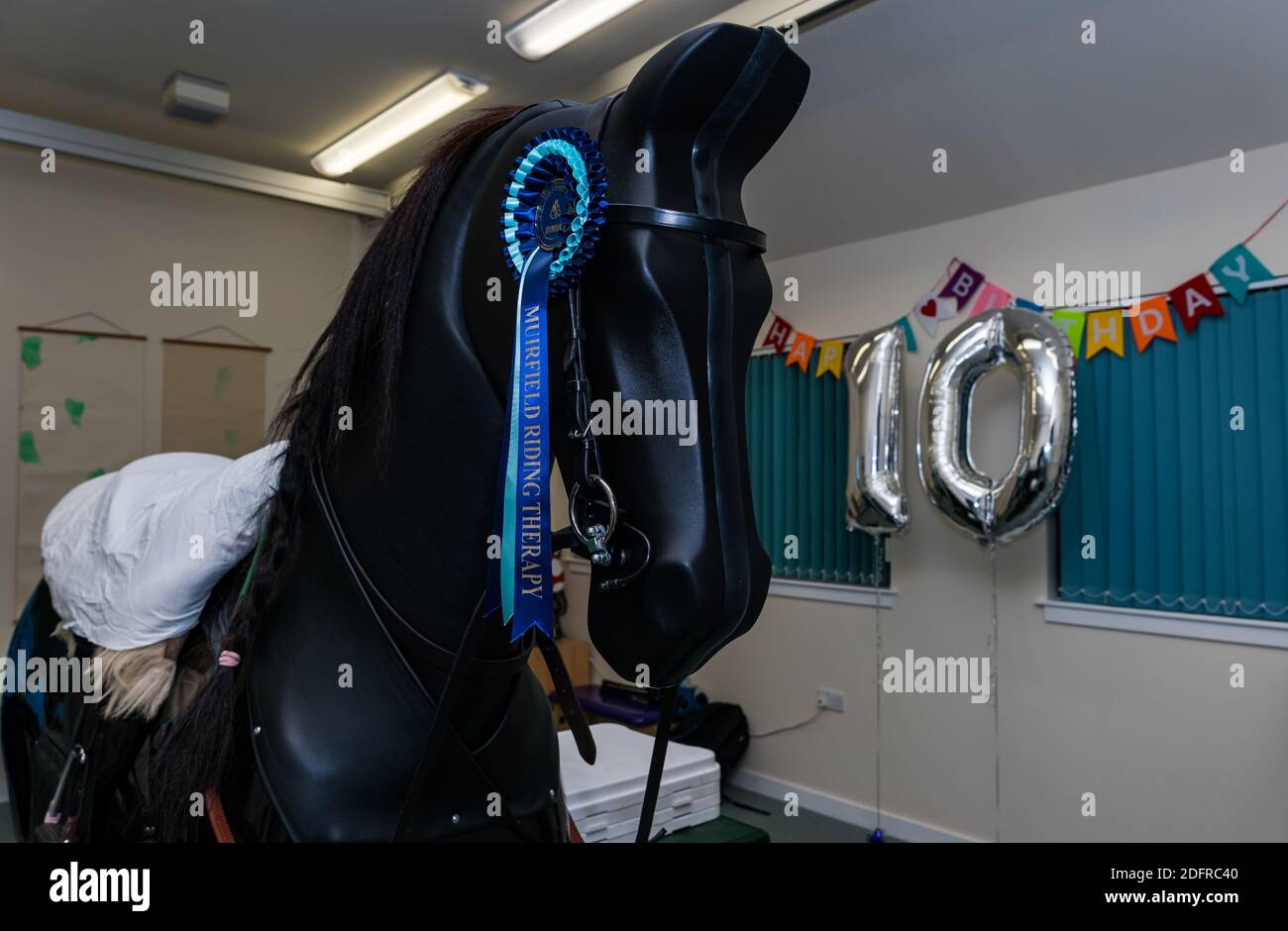 Simulateur mécanique d'équitation à Muirfield Riding Therapy for the Disabled, East Lothian, Écosse, Royaume-Uni Banque D'Images