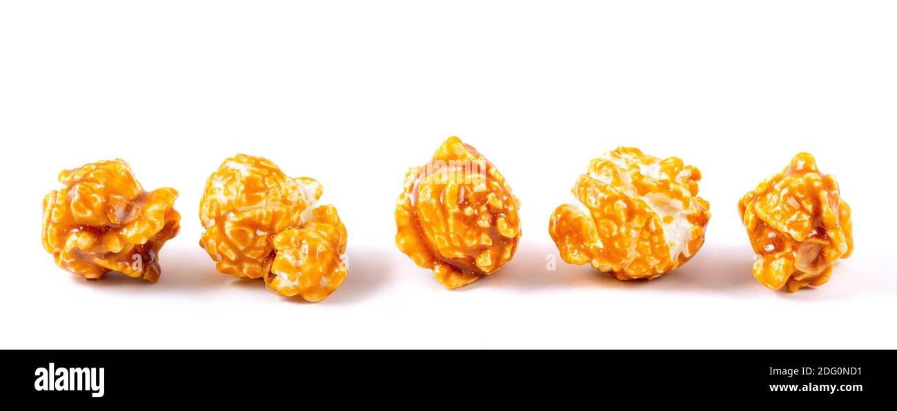 Morceaux de pop-corn sucrée au caramel macro doré sur fond blanc Banque D'Images