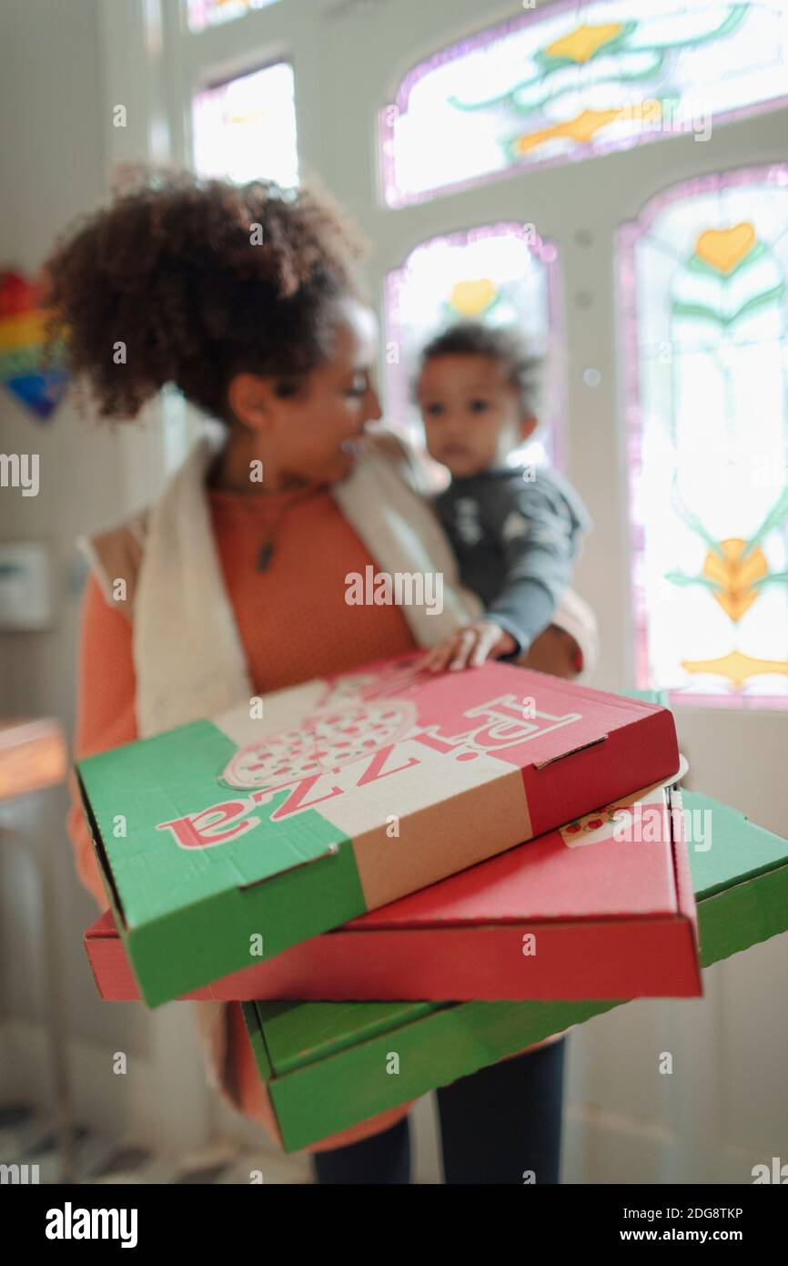 La mère et la petite fille reçoivent une livraison de pizza à la porte d'entrée Banque D'Images