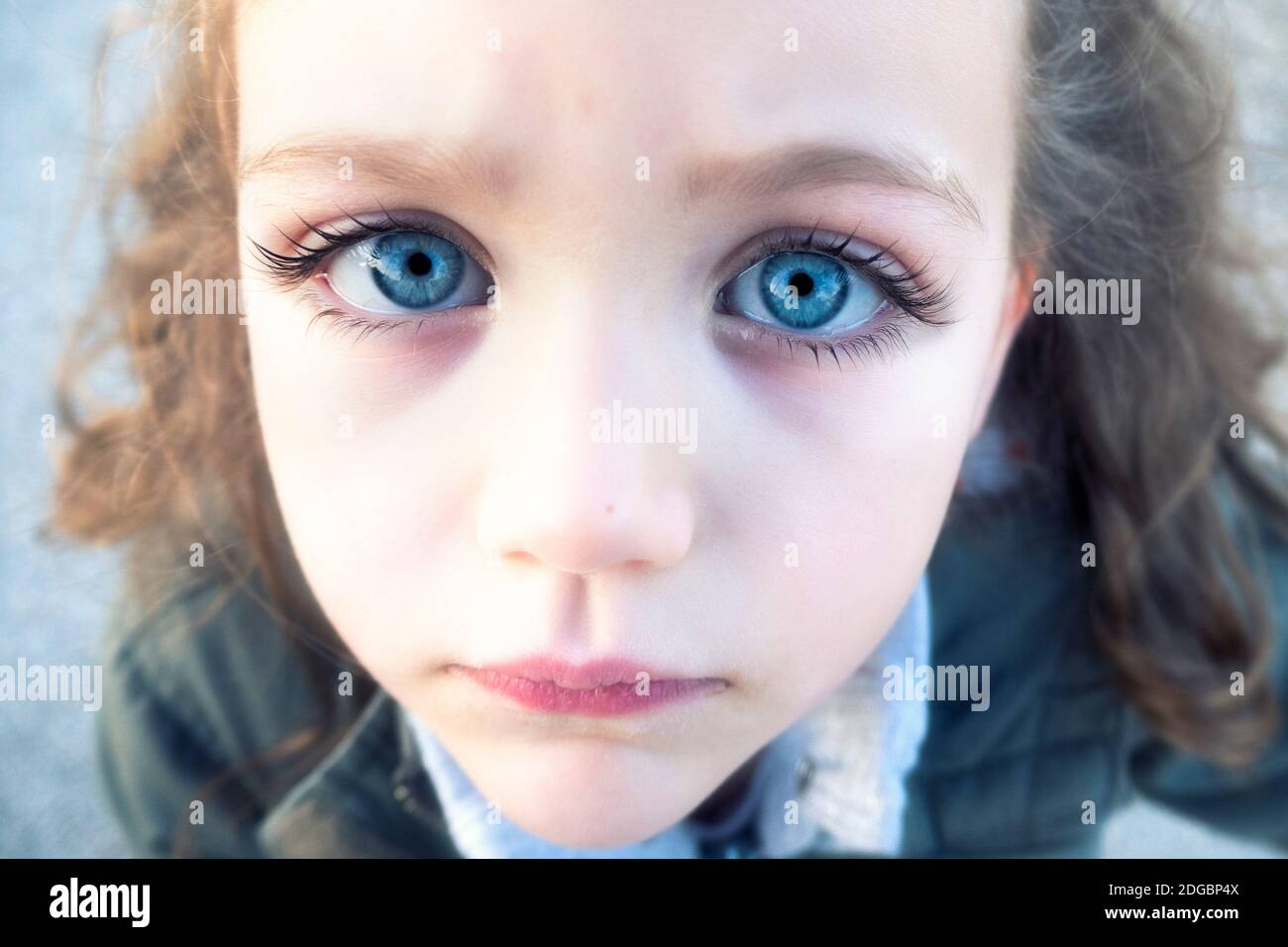 Gros plan Portrait d'une belle fille avec des yeux bleus perçant Banque D'Images