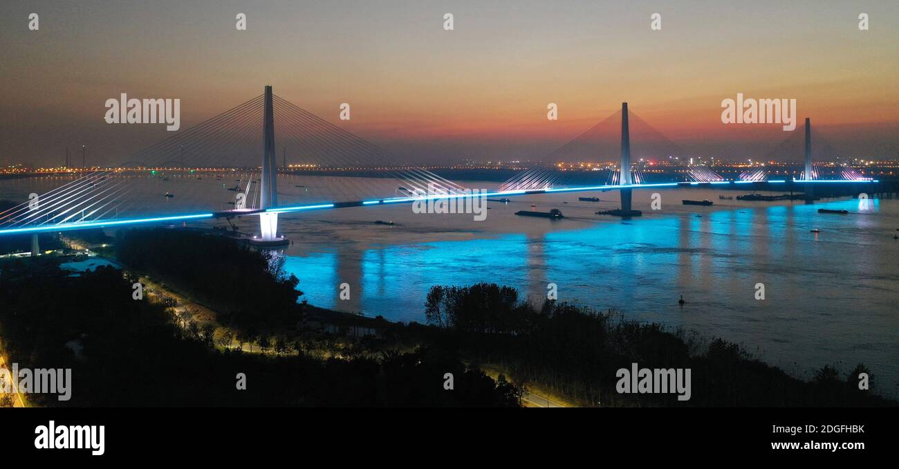 Une vue aérienne des lampadaires le long du pont du cinquième Yangtze a été activée et désactivée tour à tour pour tester le système d'éclairage, qui sera complètement terminé Banque D'Images