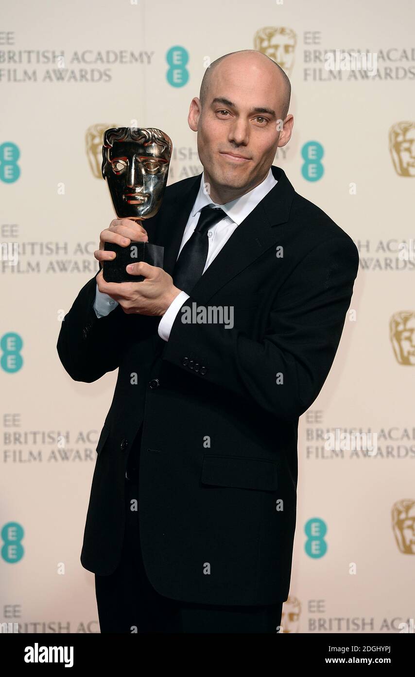 Joshua Oppenheimer avec le prix documentaire pour « l'acte de tuer », à l'EE British Academy film Awards 2014, au Royal Opera House, Bow Street, Londres. Banque D'Images