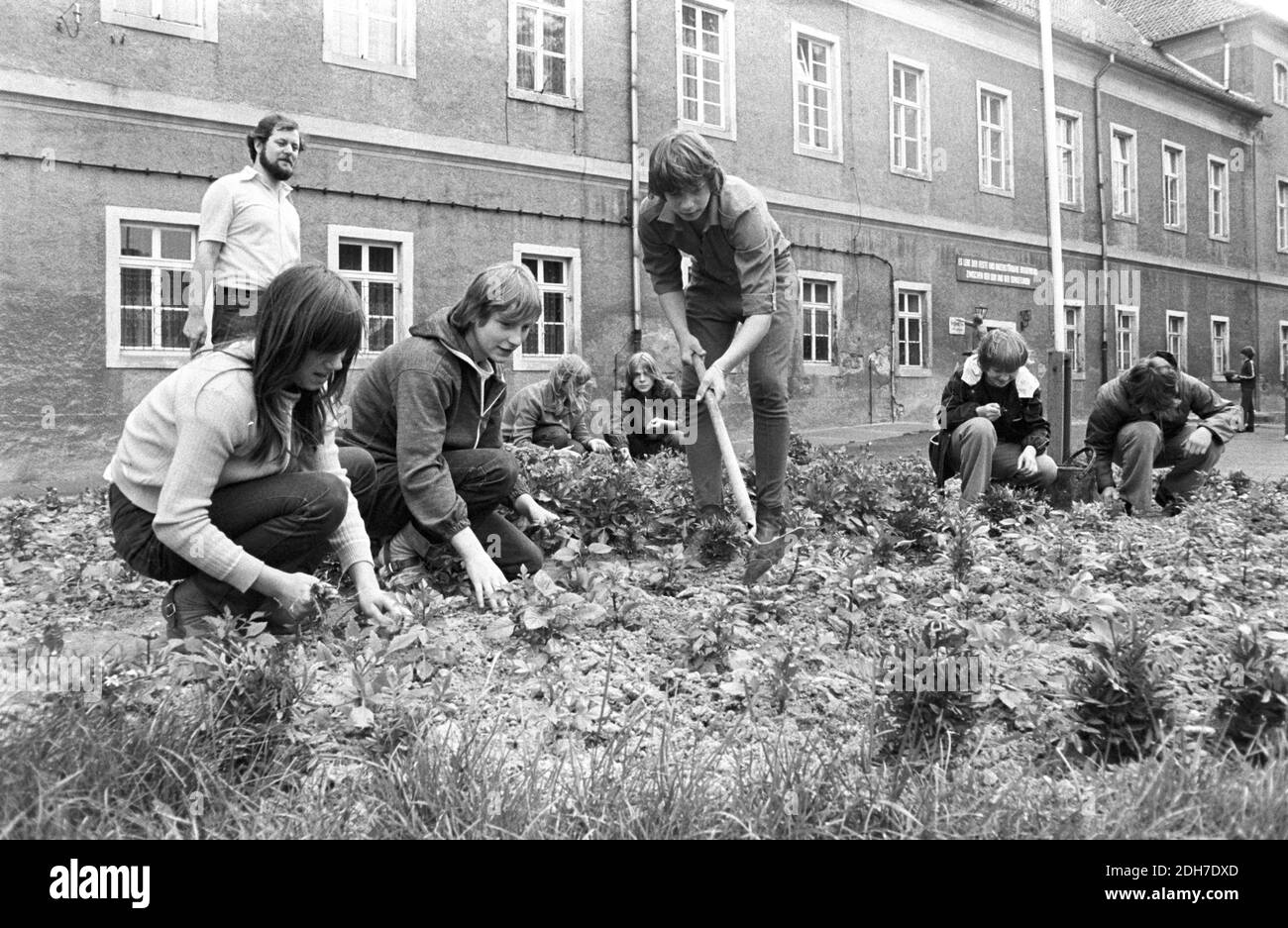 30 novembre 1983, Saxe, Zschepplin: Travaux de jardin avant, milieu des années 1980. Le château de Zschepplin est l'un des plus anciens complexes de châteaux de la région du Nord-Saxe et a été redessiné pour devenir une maison d'enfants dans les années 1950. Le bâtiment Renaissance de trois étages à quatre ailes a été érigé au-dessus d'un centre médiéval. En arrière-plan au-dessus de l'entrée, il dit: «vive la fraternité forte et indestructible entre la RDA et l'Union soviétique». Date exacte de l'enregistrement inconnue. Photo: Volkmar Heinz/dpa-Zentralbild/ZB Banque D'Images