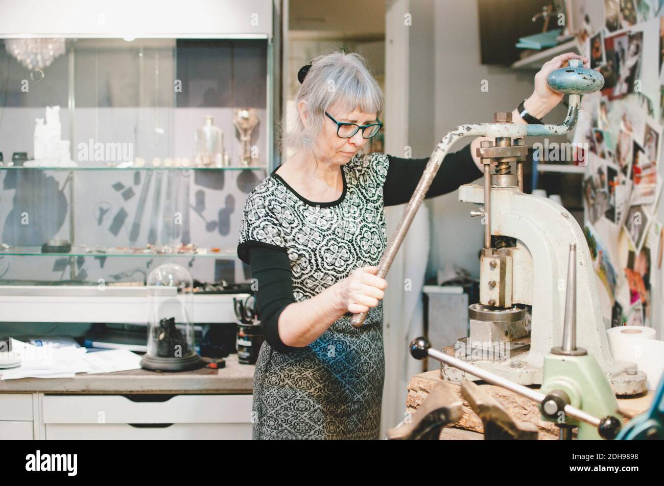 Femme senior travaillant sur une poignée d'étau en atelier Banque D'Images