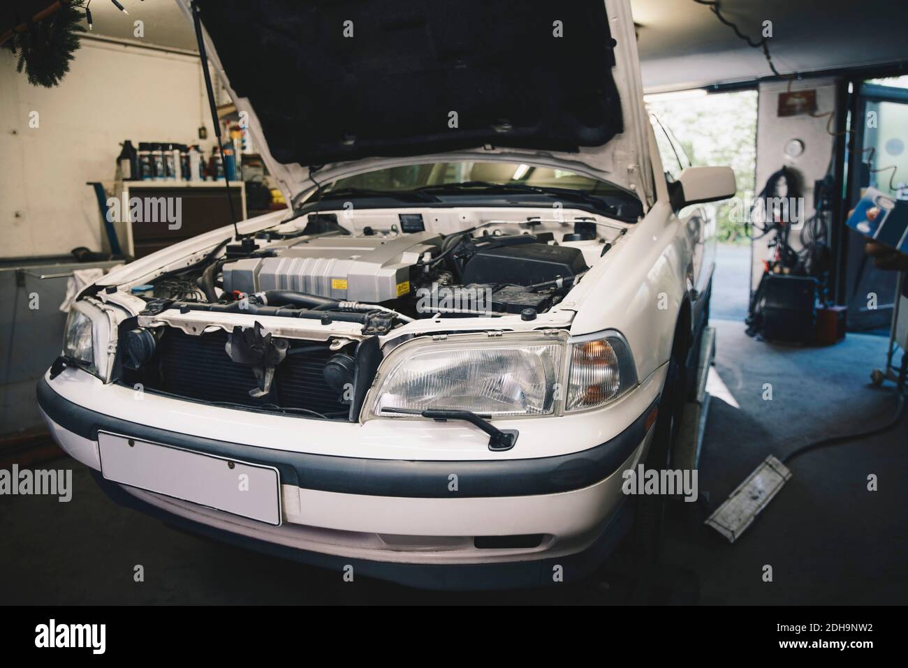 Voiture avec le capot ouvert à l'atelier de réparation automobile Banque D'Images