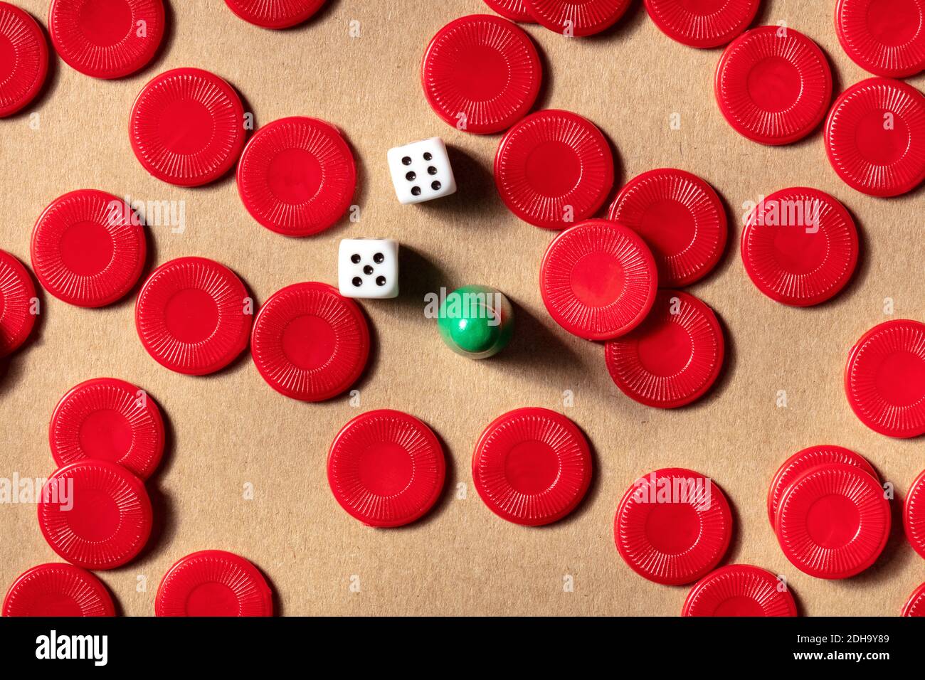 Le concept de jeux de société, un platlay d'un pion avec des pièces de jeu rouges et des dés, tiré d'en haut Banque D'Images
