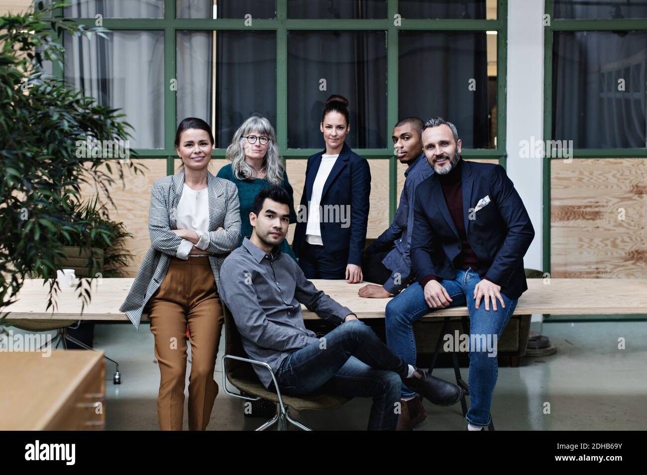 Portrait d'une équipe professionnelle confiante à table dans un bureau créatif Banque D'Images