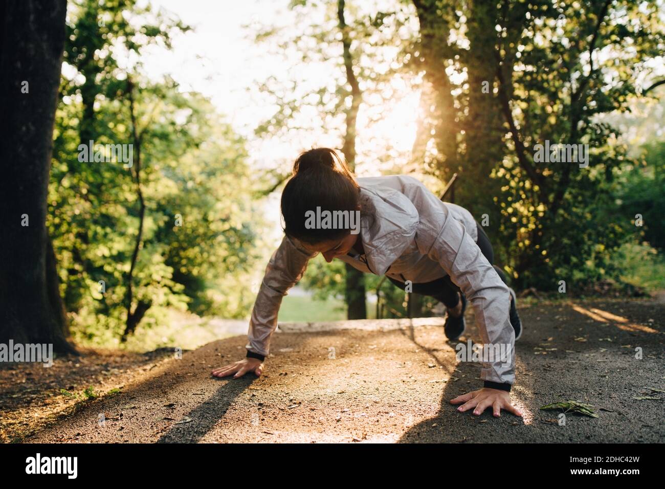 Une jeune athlète féminine fait des push-up dans le parc Banque D'Images