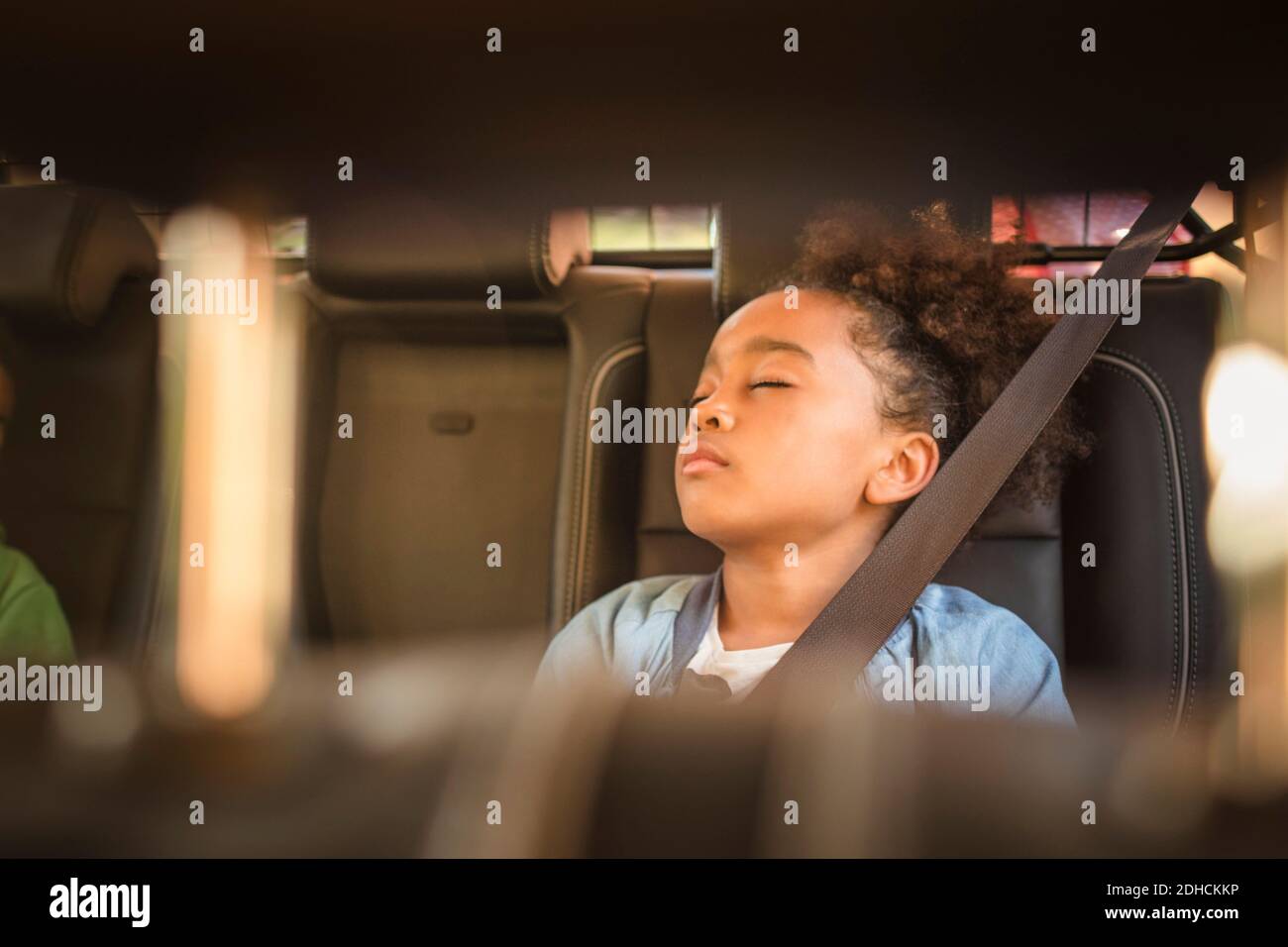 Fille fatiguée dormant en voiture électrique Banque D'Images