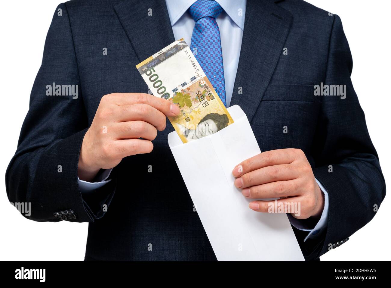 Homme d'affaires tenant la monnaie coréenne à la main sur fond blanc. Banque D'Images