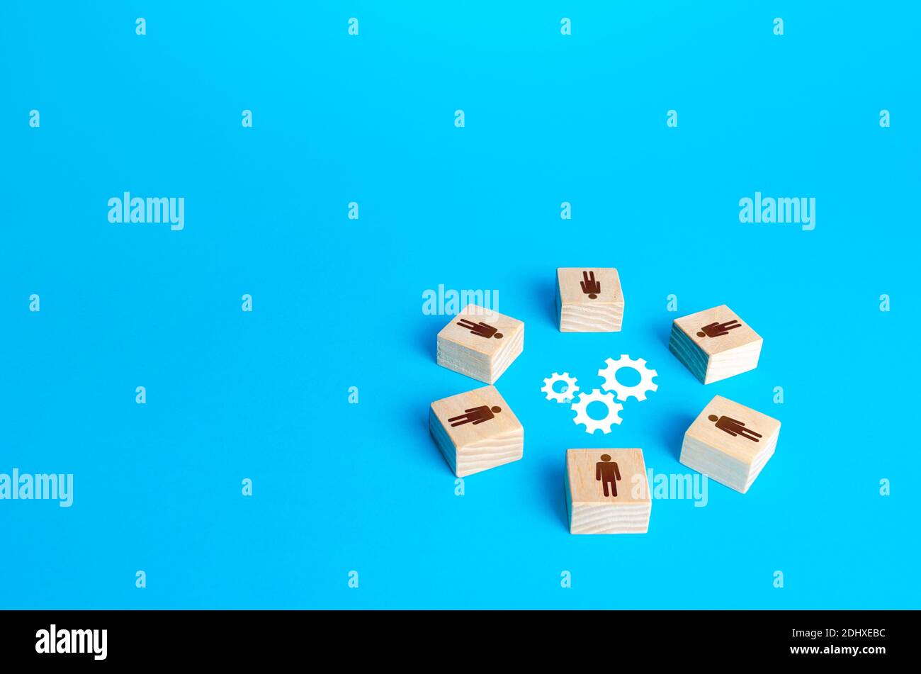 Un cercle de personnages entoure les engrenages. Brainstorming. Efforts conjoints pour résoudre les problèmes. Travail d'équipe. Négociation et dialogue. Développement de mesures Banque D'Images