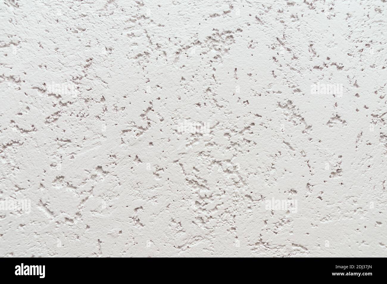 Arrière-plan de mur blanc gaufré avec plâtre décoratif. Banque D'Images