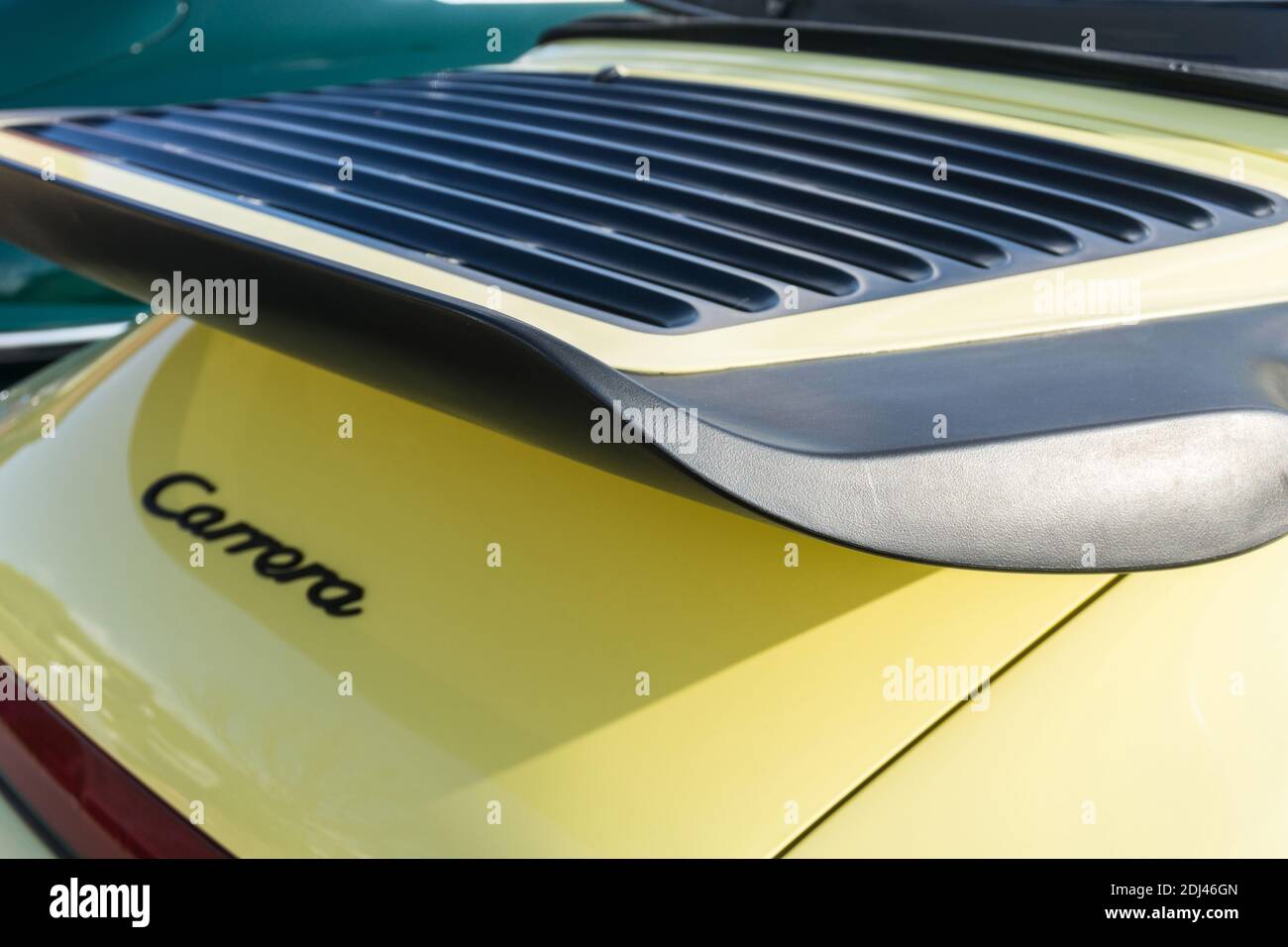 L'aile et la grille du capot moteur arrière d'une voiture de sport Porsche 911 3.2 Carrera jaune des années 80 dehors sous le soleil. Banque D'Images