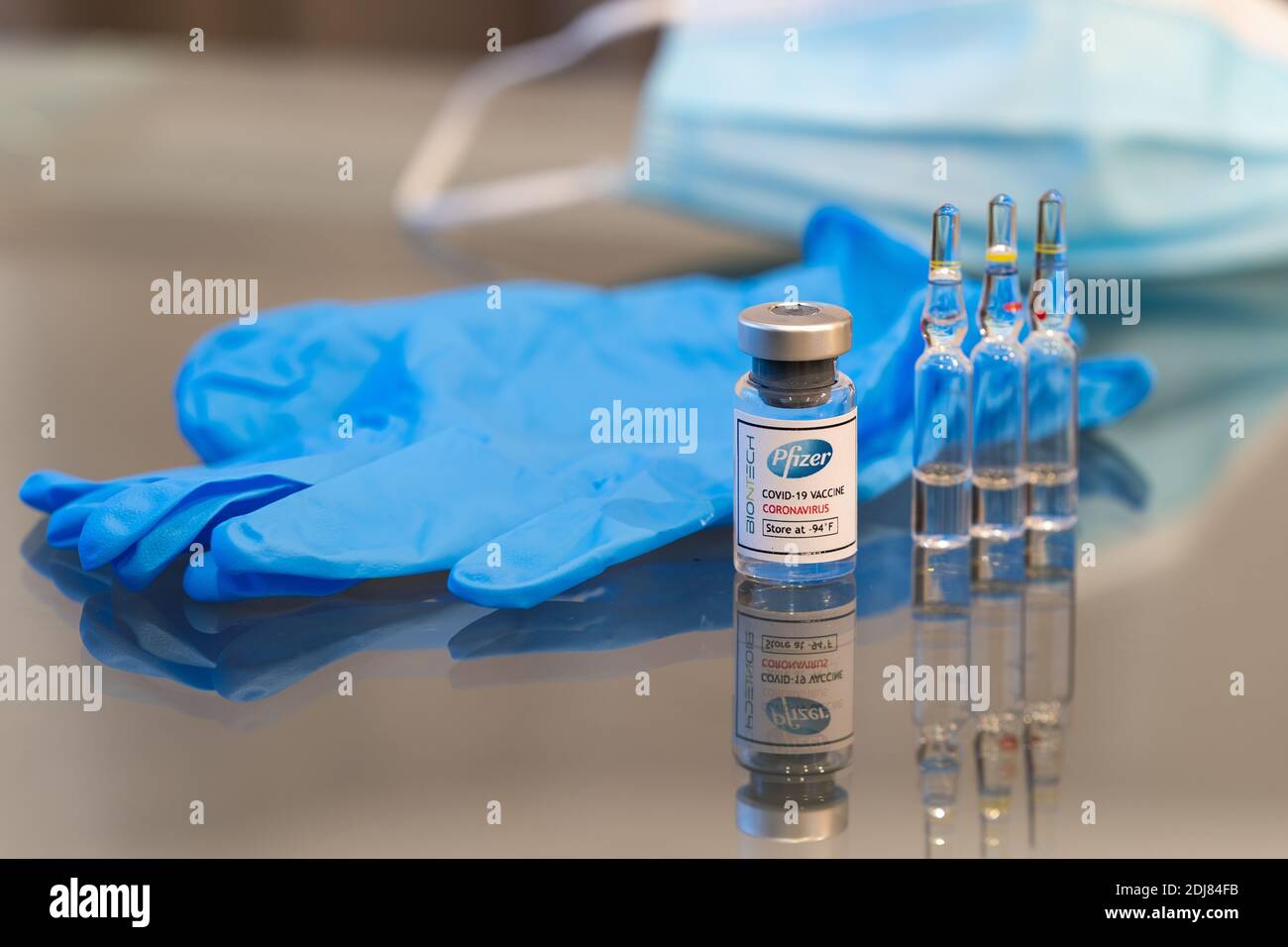 LONDRES, ANGLETERRE - 13 DÉCEMBRE 2020 : flacon en verre contenant la solution vaccinale Pfizer BioNtec COVID-19 coronavirus prête à l'emploi avec 3 verre ampo Banque D'Images