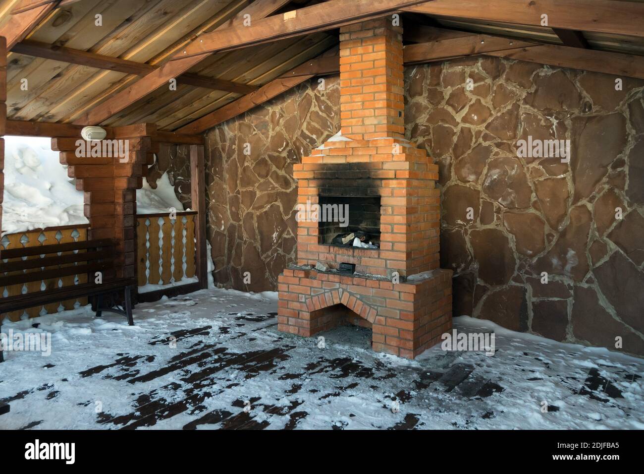 Un endroit spécialement équipé pour les loisirs d'hiver avec une cheminée en briques sous le toit. Banque D'Images