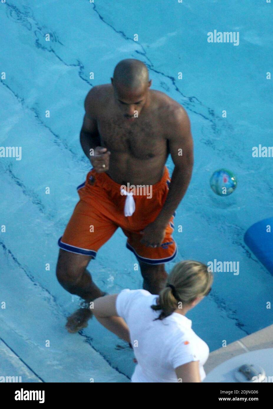 Exclusif !! Thierry Henry, joueur de football de France et d'Arsenal, donne à sa fille des leçons de natation et de contrôle du ballon. La femme Nicole Merry, qui a passé le matin à bronzer, regarda et ressemblait à toute maman fière avec son appareil photo numérique. Le matin, Nicole a pris un bain de soleil en solo pendant une heure et demie chaque jour tout en discutant sans arrêt sur son téléphone mobile, Miami Beach, FL, 7/25/06 Banque D'Images