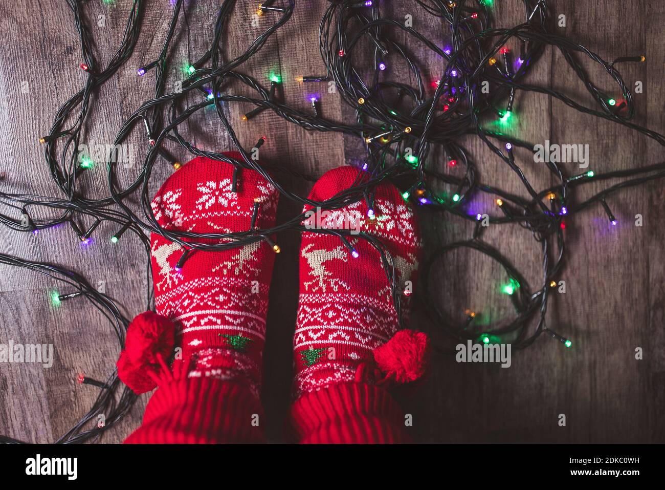 Des lumières de Noël emmêlées aux pieds sur le sol Banque D'Images