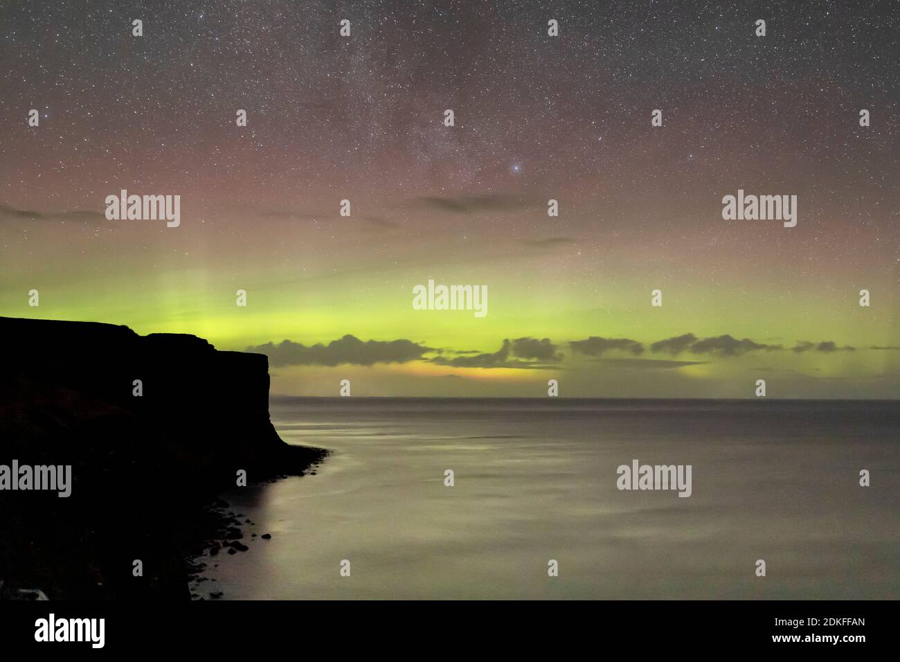 Ciel nocturne à Kilt Rock sur l'île de Skye En Écosse avec des étoiles et des lumières du nord Banque D'Images