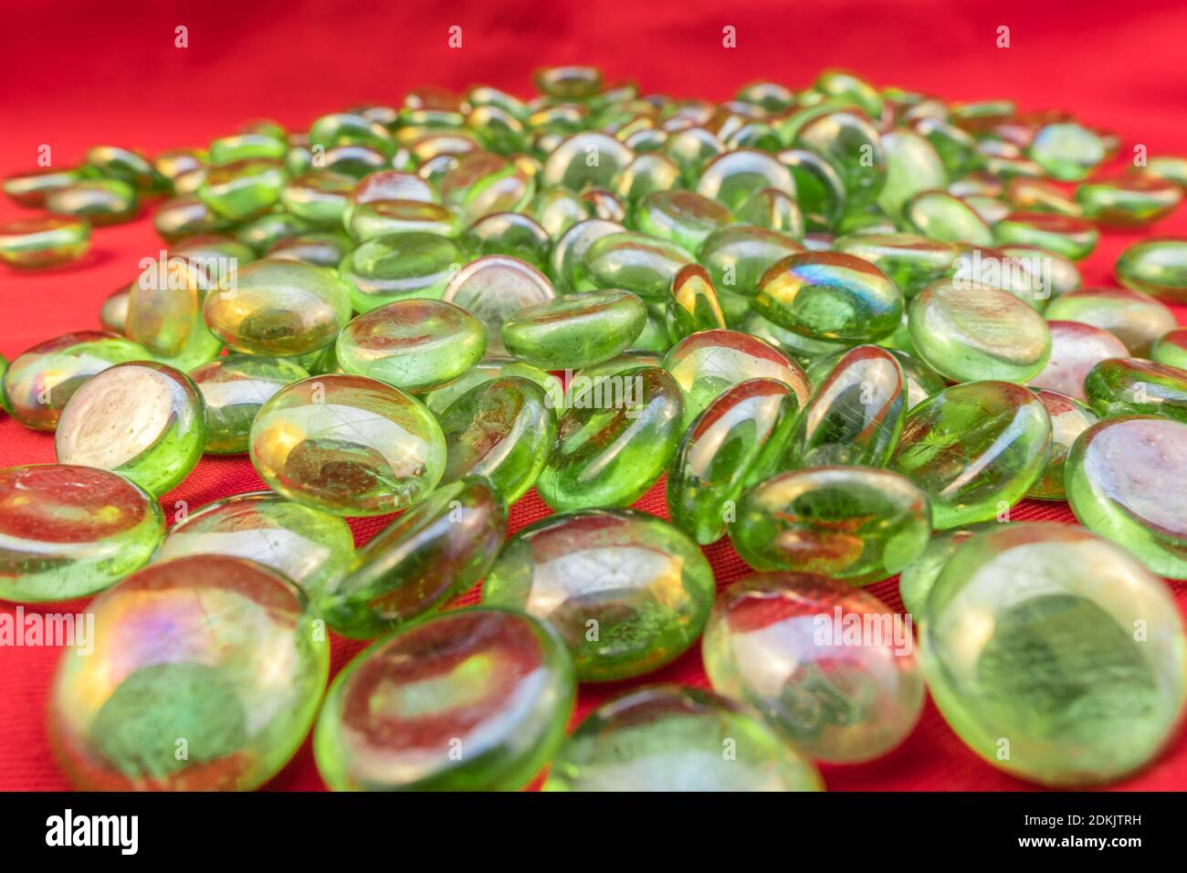 Perles de verre vertes sur fond rouge vif Banque D'Images