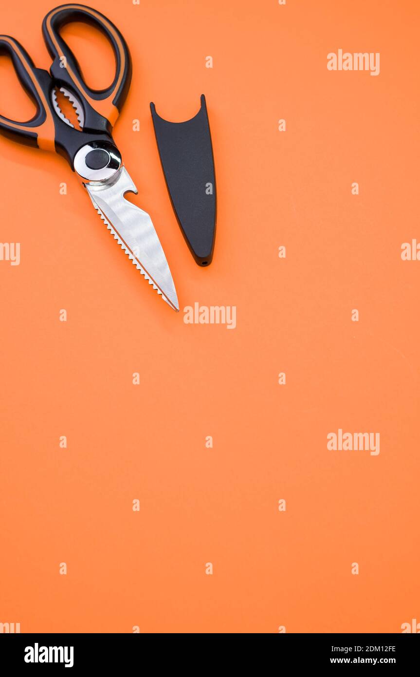 Un cliché vertical de ciseaux isolés sur fond rose. Outil de coupe avec lames zigzag, copier l'espace Banque D'Images