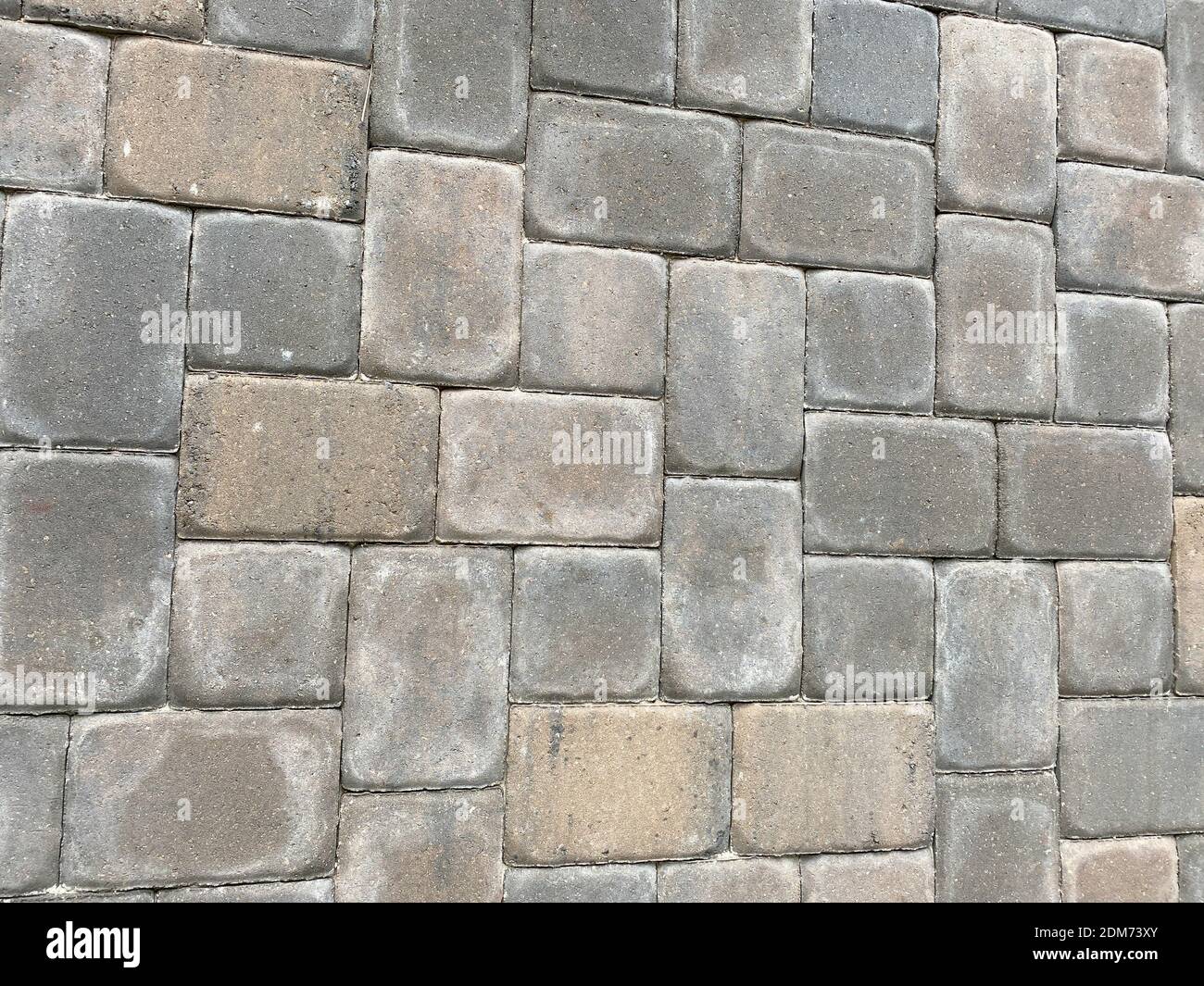 Arrière-plan du finisseur de briques dans un motif aléatoire avec des tons de brun, de gris et de brun clair. Banque D'Images