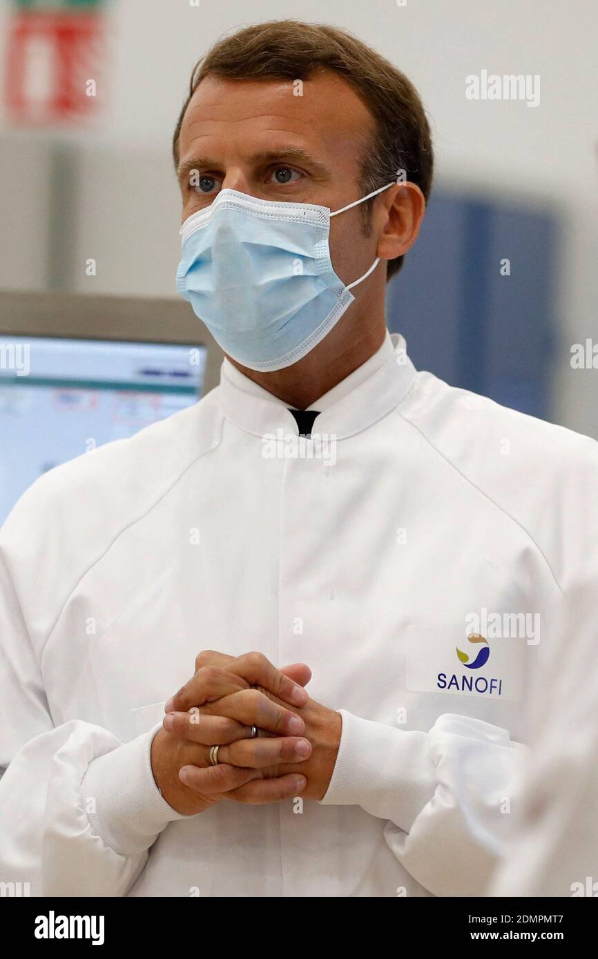 File photo dated June 16, 2020 of French President Emmanuel Macron, wearing  a protective face mask, talks with researchers as he visits an industrial  development laboratory at the French drugmaker's vaccine unit