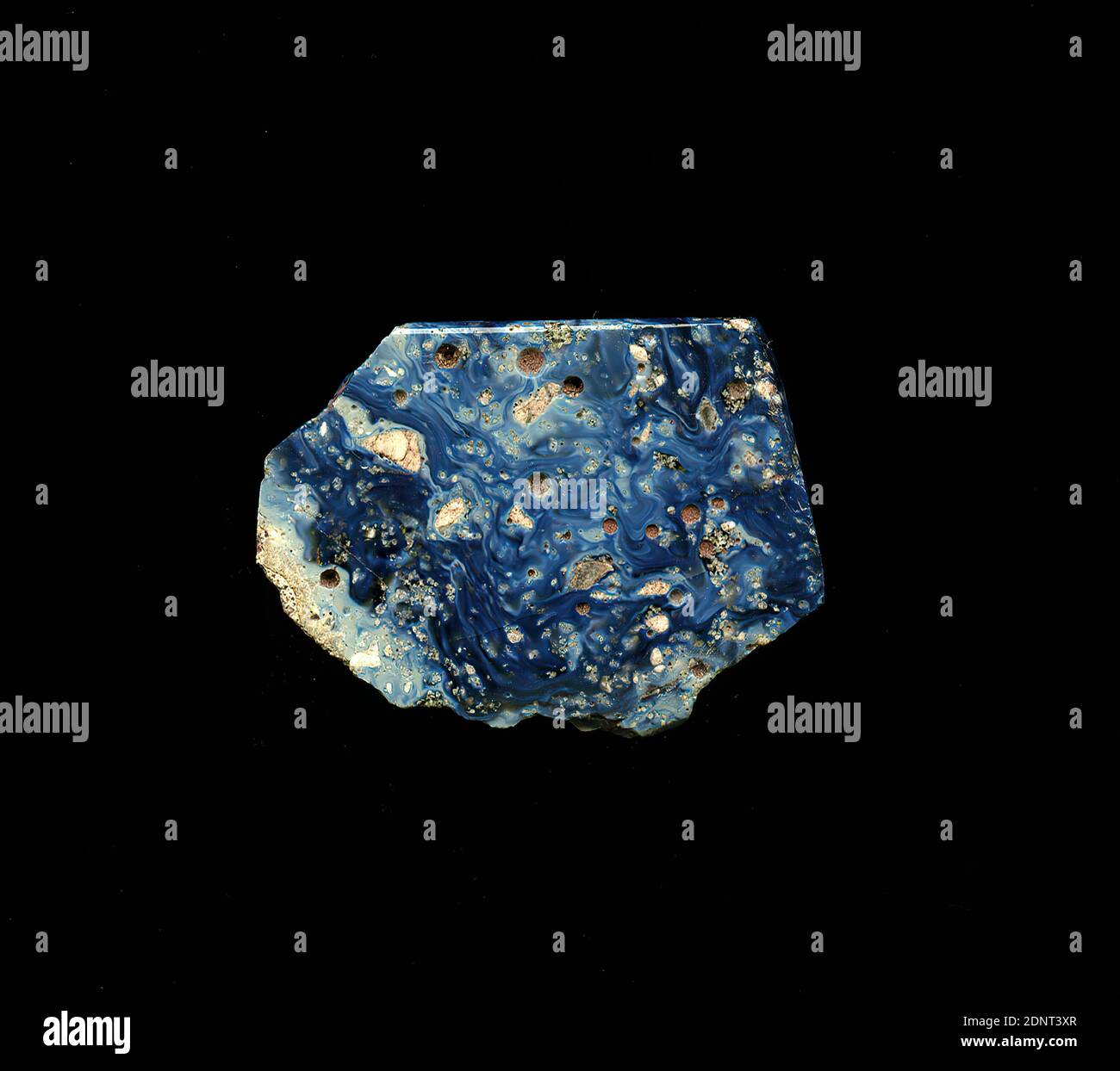 Fragment d'un vaisseau, verre, pressé, coupé, Total: Hauteur: 1.80 cm; largeur: 2.80 cm, conteneur, stockage, travail de cuisine, début de la période impériale, UNE légère courbure du fragment de verre permet l'affectation à un vaisseau, éventuellement un bol. Le petit fragment de verre est marbré de bleu foncé à bleu clair. Les petits trous sont visibles sur la surface. Pour la production, des verres de différentes couleurs ont été formés en tubes et en tiges. Ils ont été pressés ensemble et chauffés, ce qui a donné une longue tige. Le verre maintenant coupé en tranches avait des motifs amorphes ou floraux différents. Banque D'Images