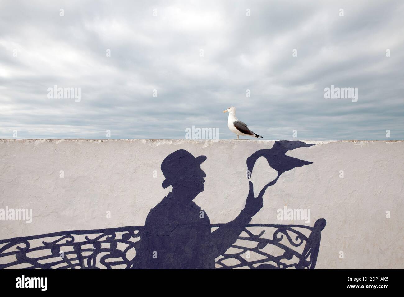 Maroc, Essaouira, la peinture murale d'un homme portant un chapeau melon avec mouette Banque D'Images