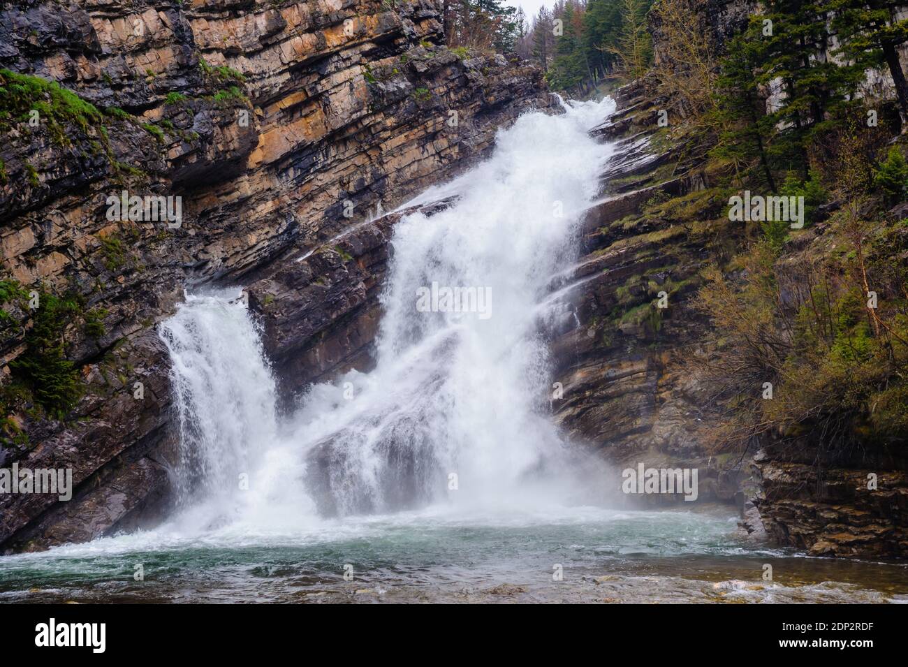 Cascade en cascade sur des couches de roche diagonales. Banque D'Images