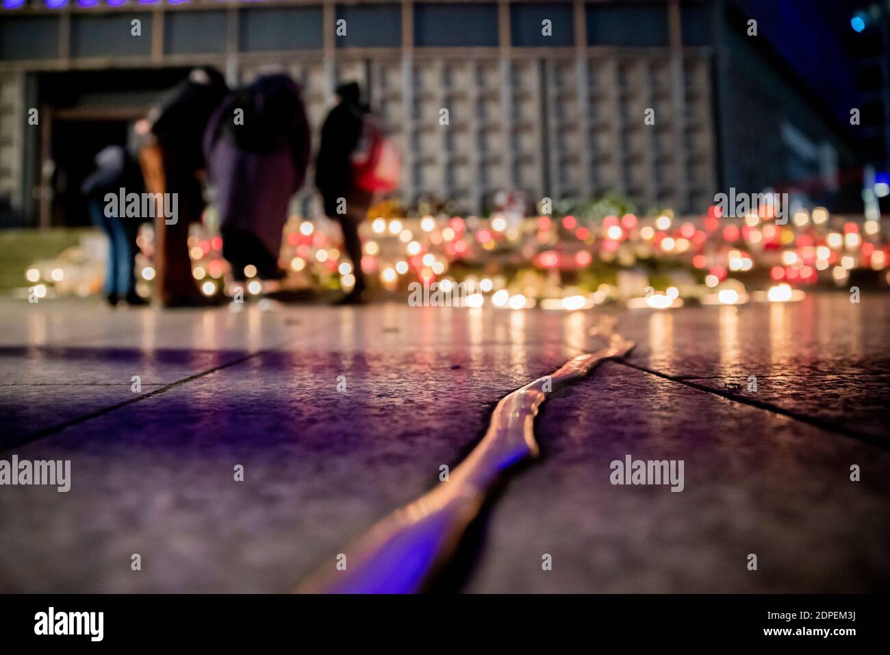 Berlin, Allemagne. 19 décembre 2020. Les gens se tiennent au mémorial du 'Goldener Riss', où de nombreuses bougies sont allumées, pendant le service commémoratif du quatrième anniversaire de l'attaque islamiste sur le marché de Noël de Breitscheidplatz. Credit: Christoph Soeder/dpa/Alay Live News Banque D'Images