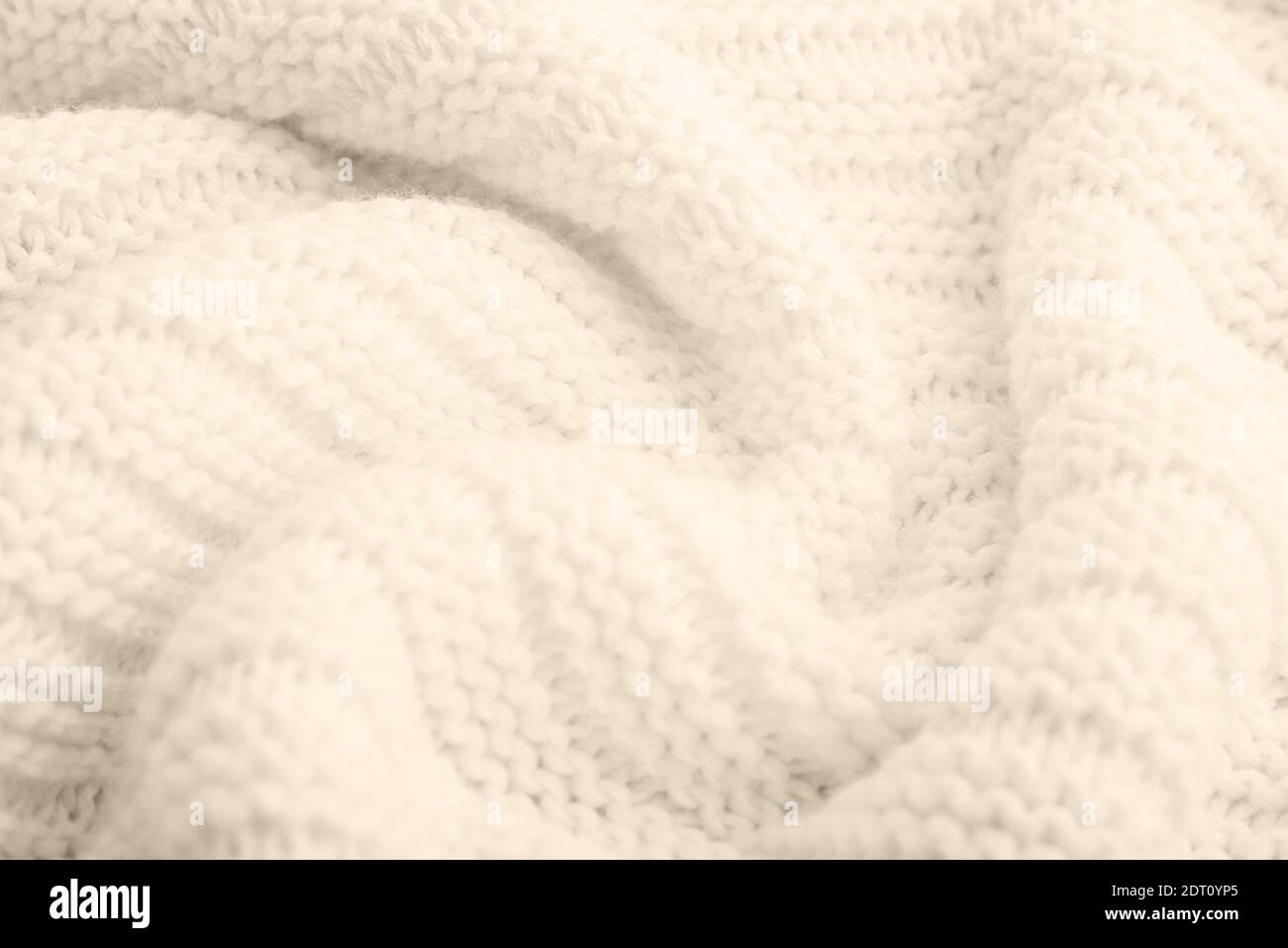 Gros plan sur fond texturé tricoté beige. Couleur tendance. Banque D'Images