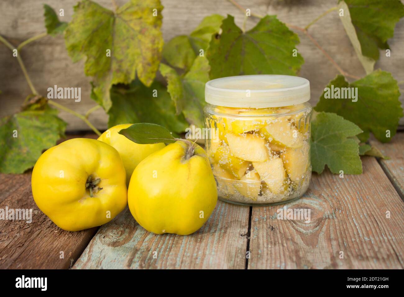 Coing mûr, coing confits conservé dans le sucre. Coce jaune sur fond de bois. Banque D'Images