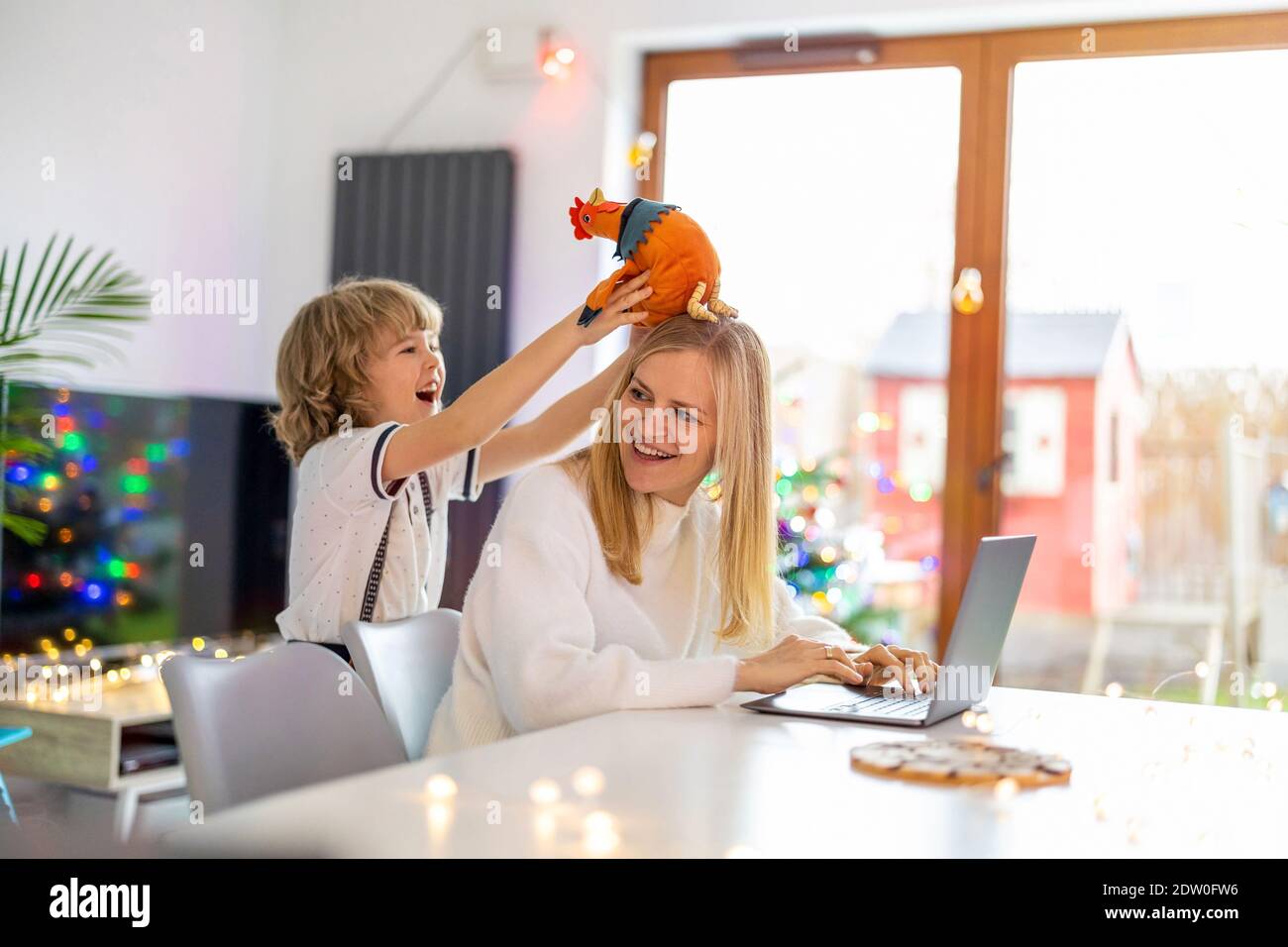 Mère essayant de travailler de la maison avec ses enfants comme une entreprise Banque D'Images