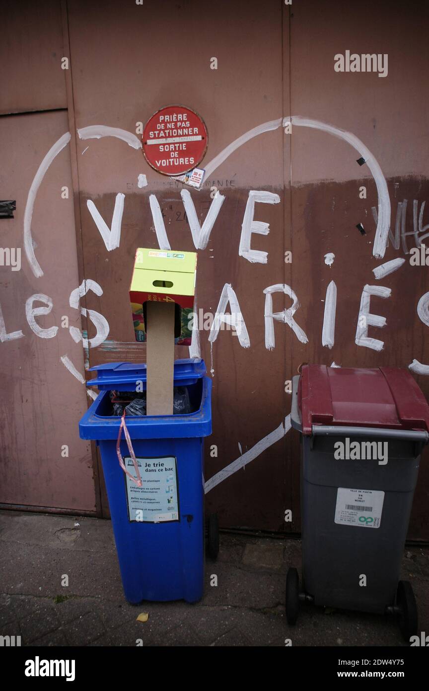 TEXTE « LONG LIVE THE NEWLYWEDS » PEINT SUR LE DEVANT D'UN PORTE DE GARAGE AVEC UN PANNEAU D'INTERDICTION DE STATIONNEMENT OÙ SE TROUVENT UN COUPLE DE POUBELLES - PARIS FRANCE - PHOTOGRAPHIE DE RUE - ARCHIVE COULEUR © F.BEAUMONT Banque D'Images