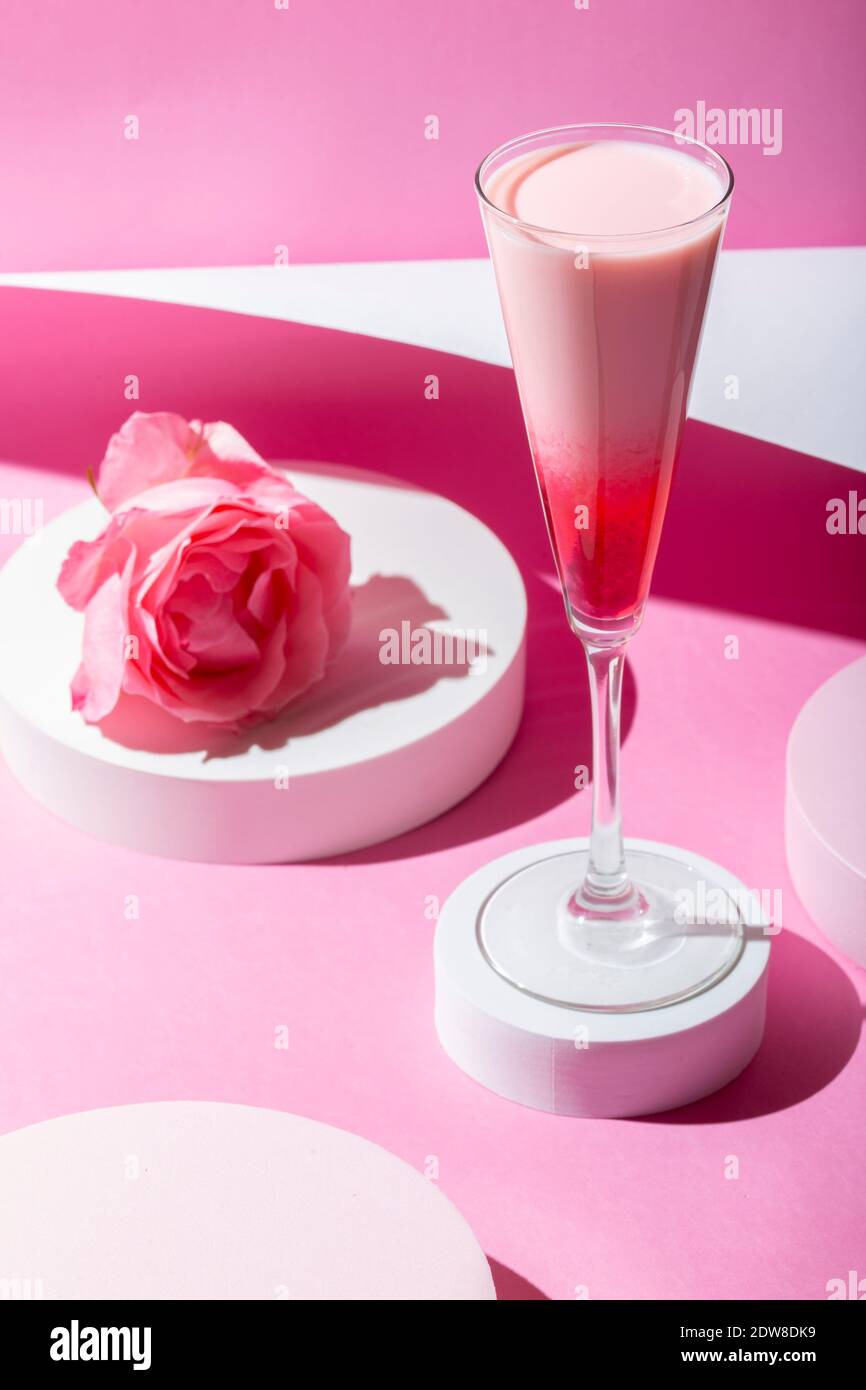 Cocktail rose sur fond rose. Design minimaliste. Banque D'Images