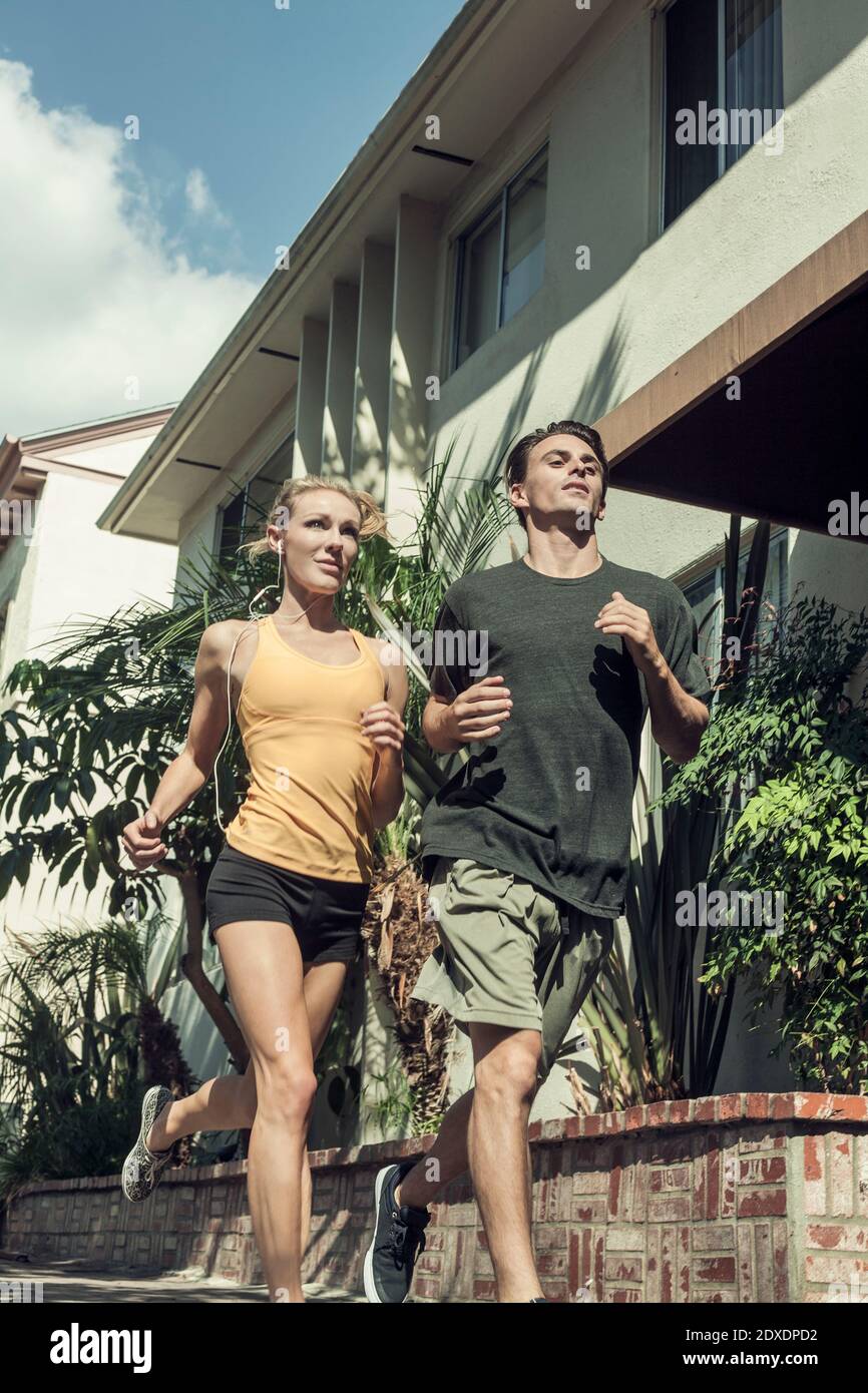 Un jeune homme et une jeune femme qui se rassemblent dans la rue sous le soleil jour Banque D'Images