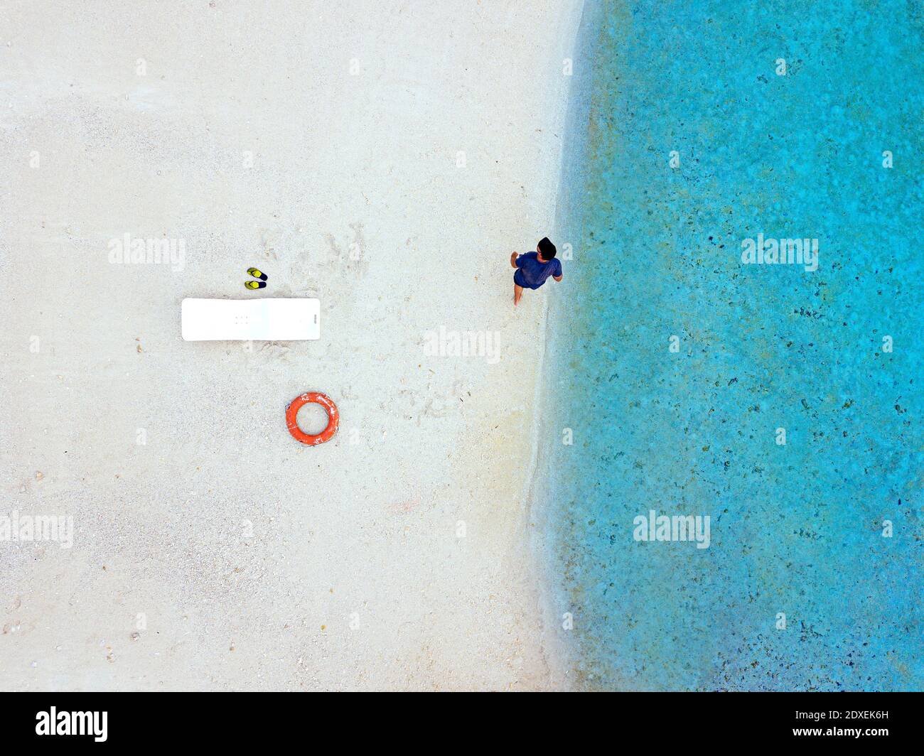 Visite touristique sans souci à pied près d'une chaise longue sur la rive à plage tropicale Banque D'Images