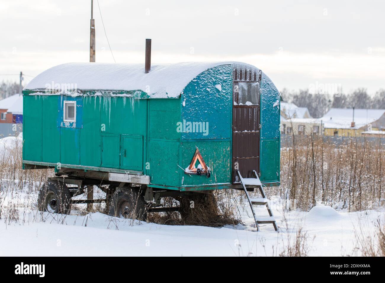 Une remorque ou un wagon congelé abandonné recouvert de neige à l'extérieur en hiver jour Banque D'Images